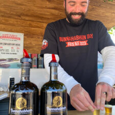 Man serving Whisky at Bunnahabhain Distillery on Islay Scotland